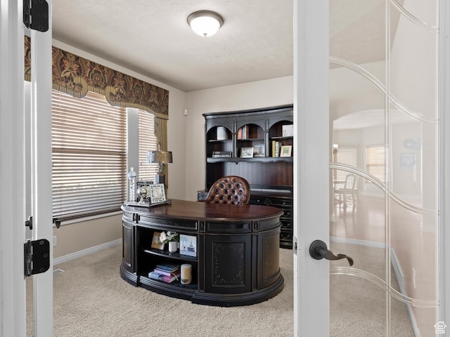 carpeted office space with baseboards