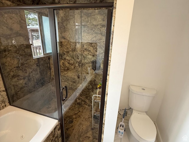 bathroom with toilet, a jetted tub, and a stall shower