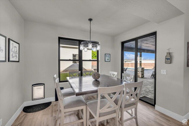 444 S 1530 W, Hurricane, UT 84737 - dining space featuring light wood-style floors, baseboards, and an inviting chandelier