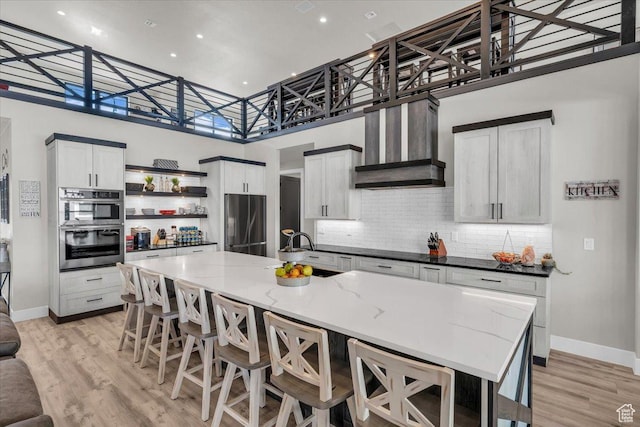 444 S 1530 W, Hurricane, UT 84737 - kitchen featuring light wood-type flooring, premium range hood, open shelves, appliances with stainless steel finishes, and a sink