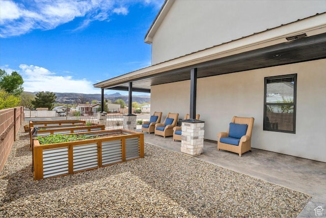 444 S 1530 W, Hurricane, UT 84737 - view of patio / terrace featuring a mountain view, fence, and a vegetable garden