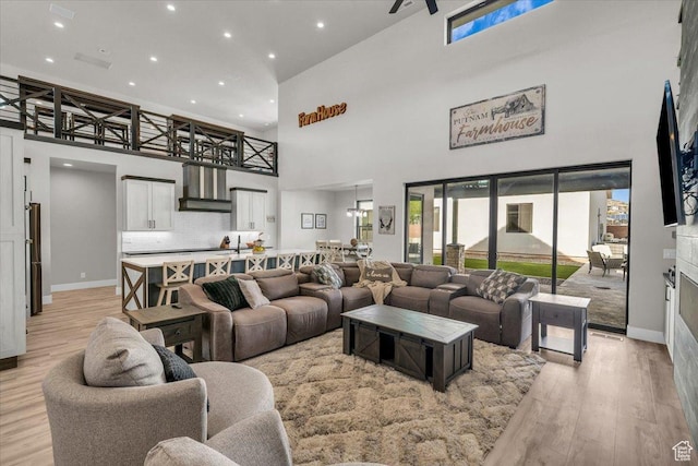 444 S 1530 W, Hurricane, UT 84737 - living room with light wood-style flooring, recessed lighting, a high ceiling, and baseboards