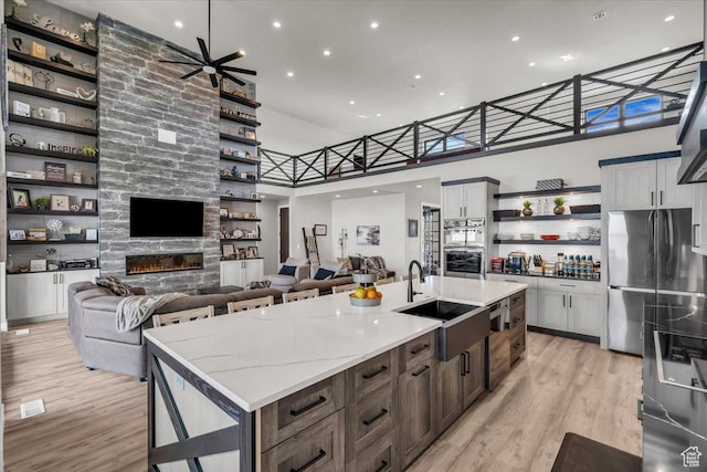 444 S 1530 W, Hurricane, UT 84737 - kitchen featuring open floor plan, freestanding refrigerator, open shelves, light wood-style floors, and a sink