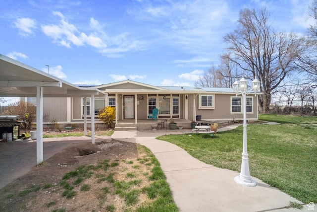 5801 S 7100 W, Hooper, UT 84315 - view of front of house featuring a front lawn, covered porch, and metal roof
