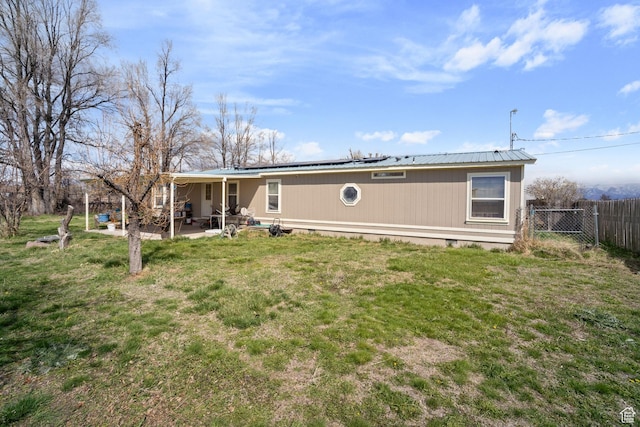 5801 S 7100 W, Hooper, UT 84315 - rear view of house with crawl space, a patio area, metal roof, fence, and a lawn
