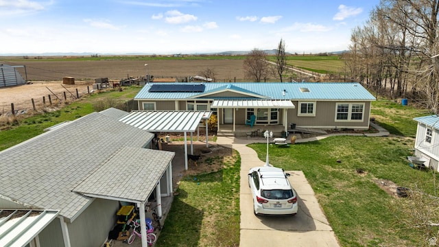 5801 S 7100 W, Hooper, UT 84315 - rear view of house featuring a rural view, a yard, metal roof, and solar panels