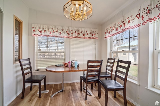 5801 S 7100 W, Hooper, UT 84315 - dining space with light wood-style flooring, an inviting chandelier, baseboards, and a healthy amount of sunlight