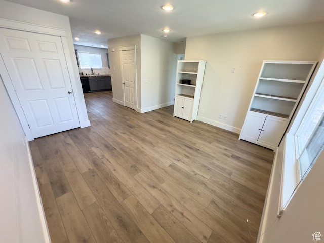 unfurnished bedroom with baseboards, recessed lighting, and wood finished floors