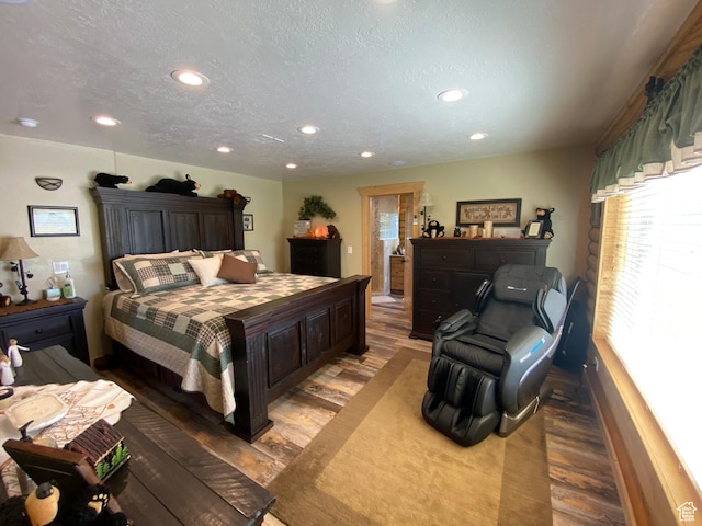 bedroom with recessed lighting, wood finished floors, and a textured ceiling