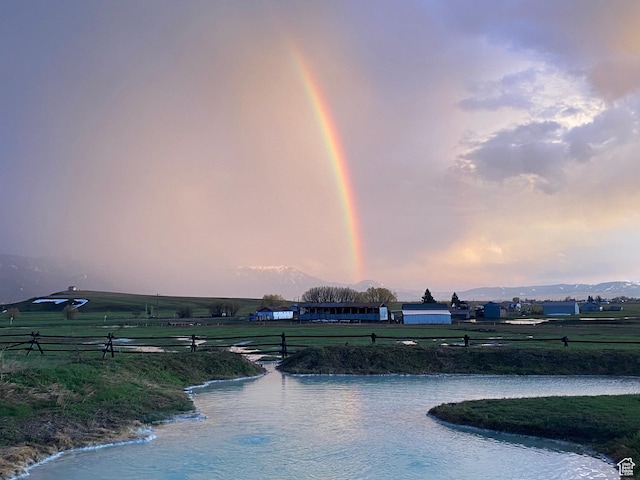 view of property's community with a yard and a water view