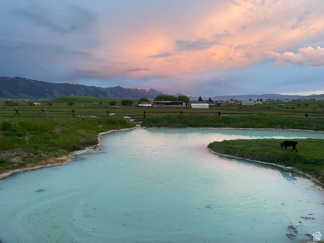 exterior space with a rural view and a water and mountain view