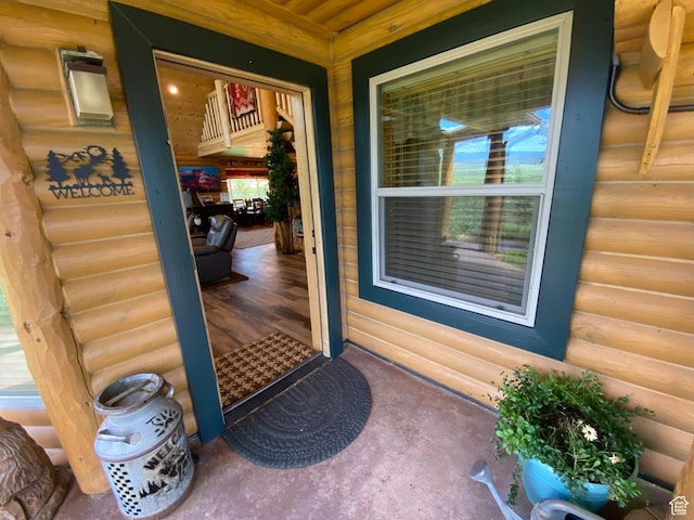 doorway to property featuring log veneer siding