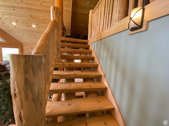 staircase featuring recessed lighting, wood ceiling, and rustic walls
