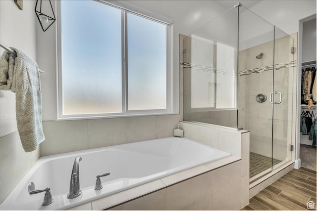 3086 W 570 N, Hurricane, UT 84737 - bathroom with a shower stall, a bath, wood finished floors, and a walk in closet