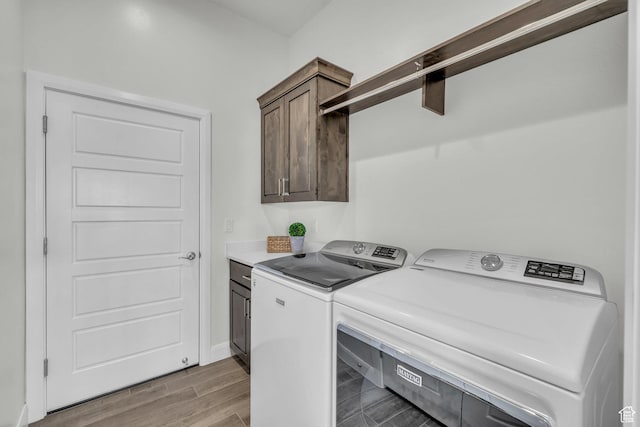 3086 W 570 N, Hurricane, UT 84737 - clothes washing area featuring cabinet space, washer and dryer, and wood finished floors