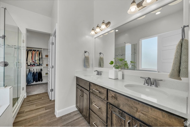 3086 W 570 N, Hurricane, UT 84737 - full bathroom featuring a stall shower, double vanity, a sink, and wood finish floors