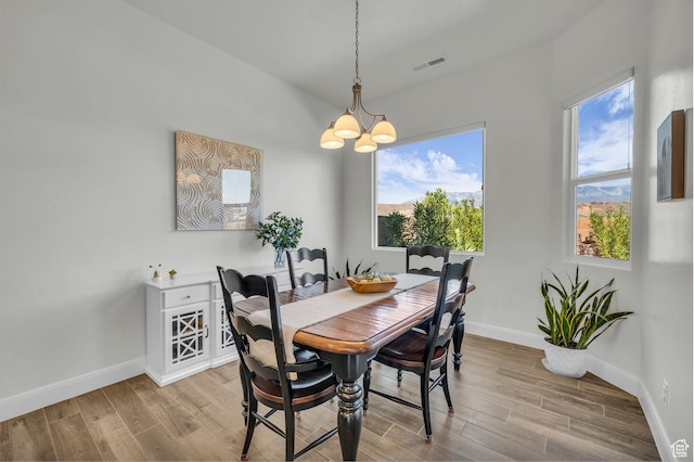 3086 W 570 N, Hurricane, UT 84737 - dining area featuring wood finished floors, an inviting chandelier, baseboards, and visible vents