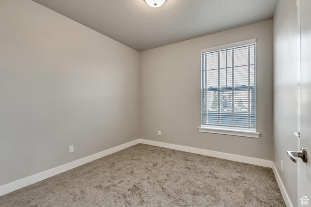 empty room with carpet and baseboards