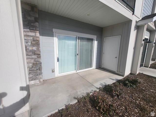 property entrance featuring stone siding