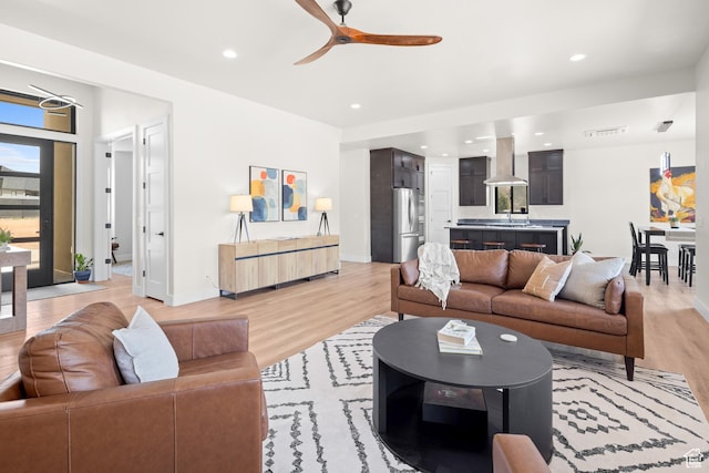 living room featuring visible vents, ceiling fan, light wood finished floors, and recessed lighting