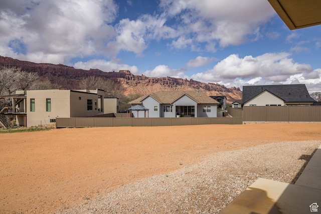 view of yard with a mountain view and fence