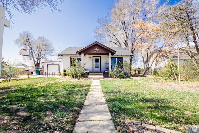 bungalow featuring a garage, a front yard, stucco siding, and fence