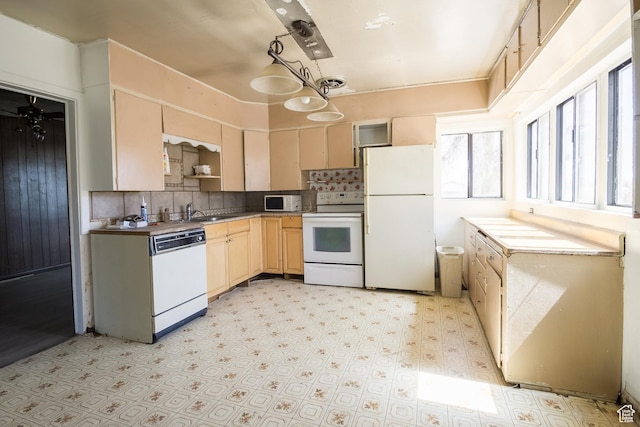 kitchen with white appliances, light brown cabinets, backsplash, and light floors