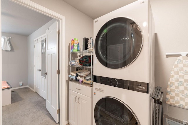 1150 W Red Hills Pkwy Unit 57, Washington, UT 84780 - laundry room featuring cabinet space, baseboards, stacked washer / dryer, and light carpet