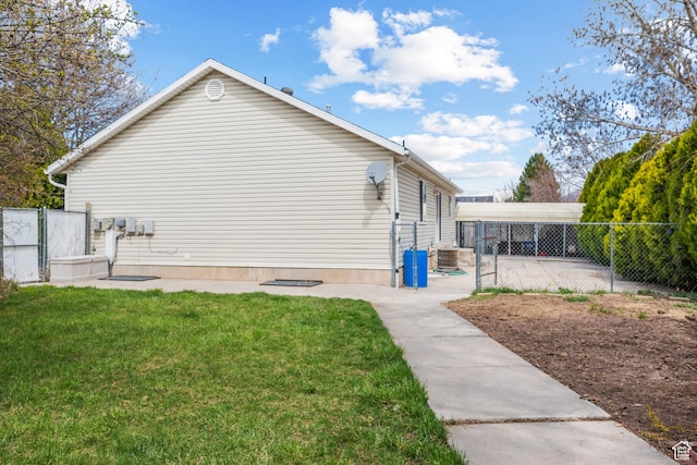 view of side of home with a yard and fence