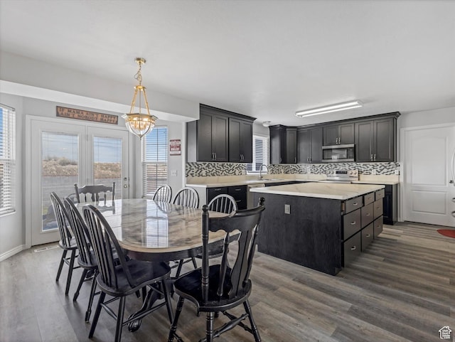 4572 W Bingham Park Dr S, West Jordan, UT 84088 - dining space featuring dark wood-style flooring, baseboards, and a chandelier