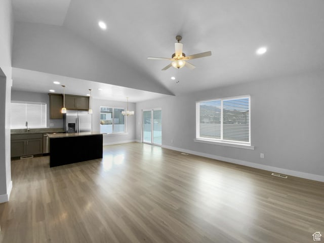 2806 E Crimson Ct, Eagle Mountain, UT 84005 - living area featuring recessed lighting, light wood-type flooring, ceiling fan with notable chandelier, and baseboards