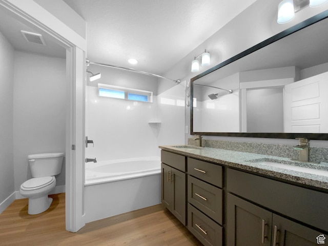 2806 E Crimson Ct, Eagle Mountain, UT 84005 - bathroom with double vanity, toilet, a sink, tub / shower combination, and wood finished floors