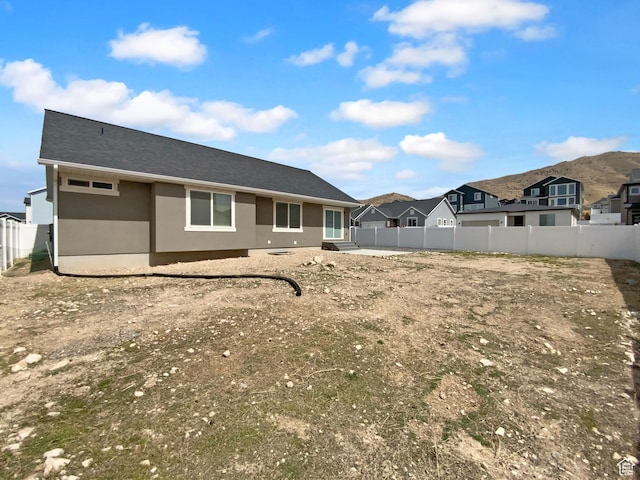 2806 E Crimson Ct, Eagle Mountain, UT 84005 - back of house with a fenced backyard, a residential view, and stucco siding