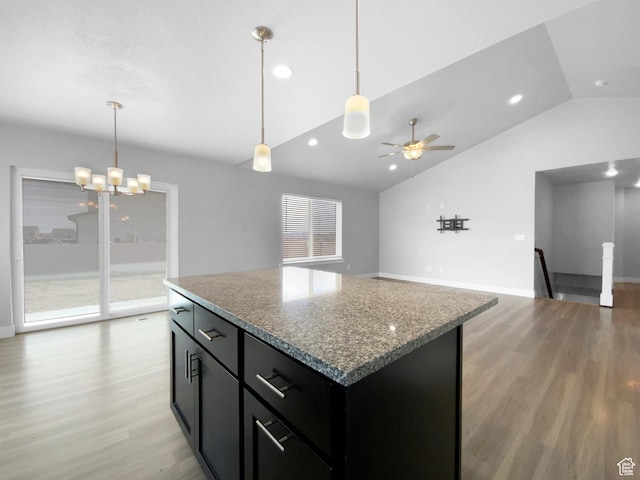 2806 E Crimson Ct, Eagle Mountain, UT 84005 - kitchen featuring ceiling fan with notable chandelier, light wood-style flooring, a kitchen island, and dark cabinets