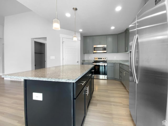 2806 E Crimson Ct, Eagle Mountain, UT 84005 - kitchen featuring light wood-style flooring, a kitchen island, recessed lighting, light stone counters, and stainless steel appliances