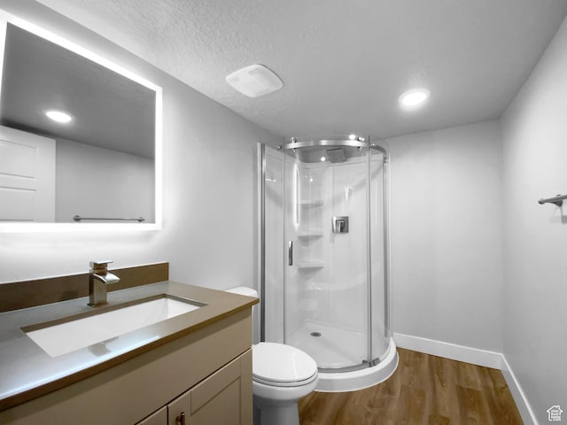 2806 E Crimson Ct, Eagle Mountain, UT 84005 - full bath featuring a shower stall, a textured ceiling, toilet, and wood finished floors