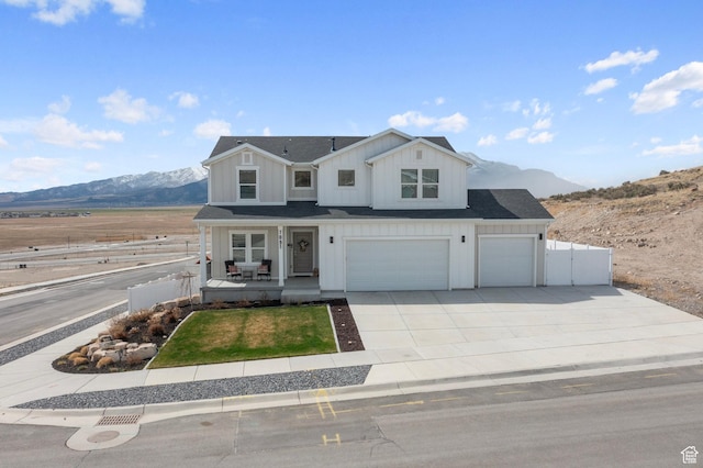 7091 N Oquirrh Ranch Pkwy, Eagle Mountain, UT 84005 - view of front facade with a mountain view, board and batten siding, fence, and covered porch