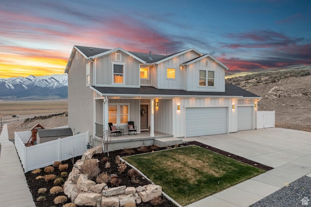 7091 N Oquirrh Ranch Pkwy, Eagle Mountain, UT 84005 - modern farmhouse featuring covered porch, a garage, board and batten siding, fence, and driveway