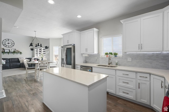 7091 N Oquirrh Ranch Pkwy, Eagle Mountain, UT 84005 - kitchen with appliances with stainless steel finishes, a sink, dark wood finished floors, and white cabinets