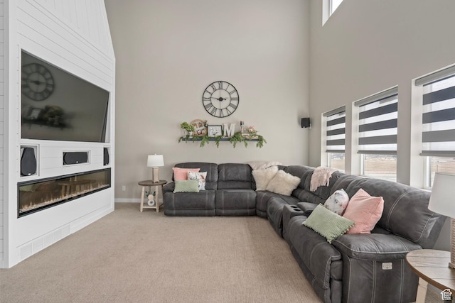 7091 N Oquirrh Ranch Pkwy, Eagle Mountain, UT 84005 - carpeted living room featuring baseboards and a towering ceiling