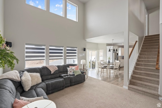 7091 N Oquirrh Ranch Pkwy, Eagle Mountain, UT 84005 - living room featuring stairway and light wood-type flooring