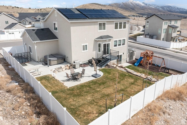 7091 N Oquirrh Ranch Pkwy, Eagle Mountain, UT 84005 - back of property with a patio, a residential view, stucco siding, a fenced backyard, and a playground
