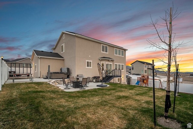 7091 N Oquirrh Ranch Pkwy, Eagle Mountain, UT 84005 - rear view of property featuring a patio area, a fenced backyard, a hot tub, a playground, and a lawn