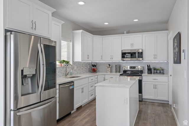7091 N Oquirrh Ranch Pkwy, Eagle Mountain, UT 84005 - kitchen with a sink, white cabinetry, dark wood-style flooring, and stainless steel appliances