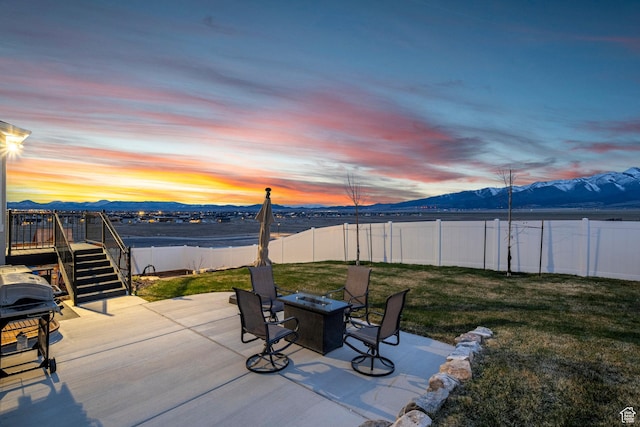 7091 N Oquirrh Ranch Pkwy, Eagle Mountain, UT 84005 - view of patio featuring a fenced backyard, stairway, a fire pit, and grilling area