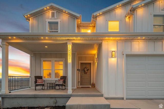 7091 N Oquirrh Ranch Pkwy, Eagle Mountain, UT 84005 - exterior space featuring board and batten siding, covered porch, and a garage