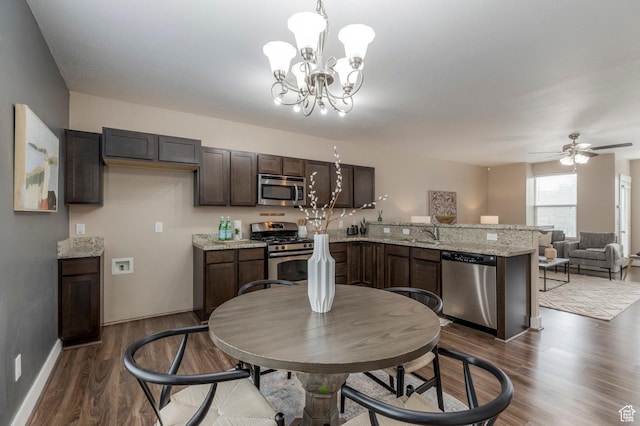 3723 S Gowan Ln W, Salt Lake City, UT 84115 - dining room with ceiling fan with notable chandelier, baseboards, and dark wood finished floors