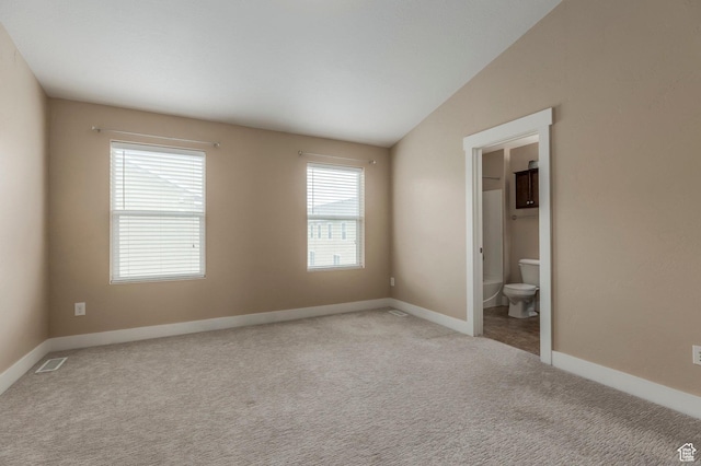 3723 S Gowan Ln W, Salt Lake City, UT 84115 - unfurnished bedroom with visible vents, baseboards, connected bathroom, vaulted ceiling, and light colored carpet