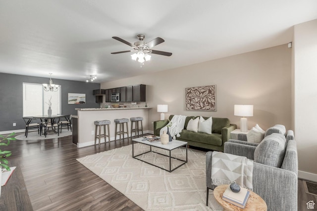 3723 S Gowan Ln W, Salt Lake City, UT 84115 - living room with ceiling fan with notable chandelier, baseboards, and dark wood finished floors