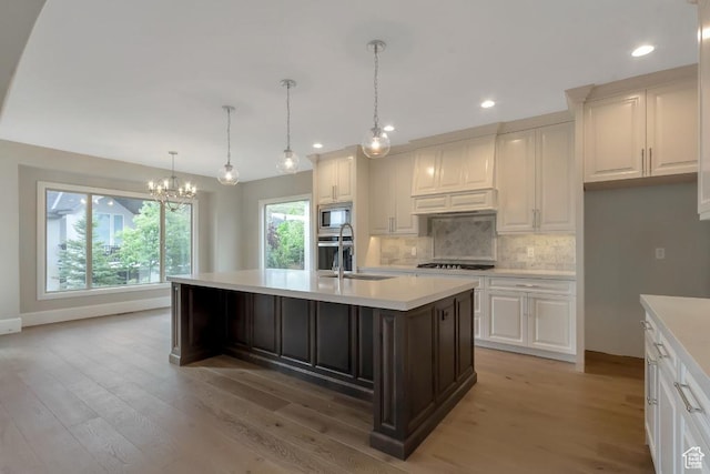 15724 S Rolling Bluff Dr, Draper Ut Cnty, UT 84020 - kitchen with appliances with stainless steel finishes, a sink, light countertops, a chandelier, and light wood-style flooring